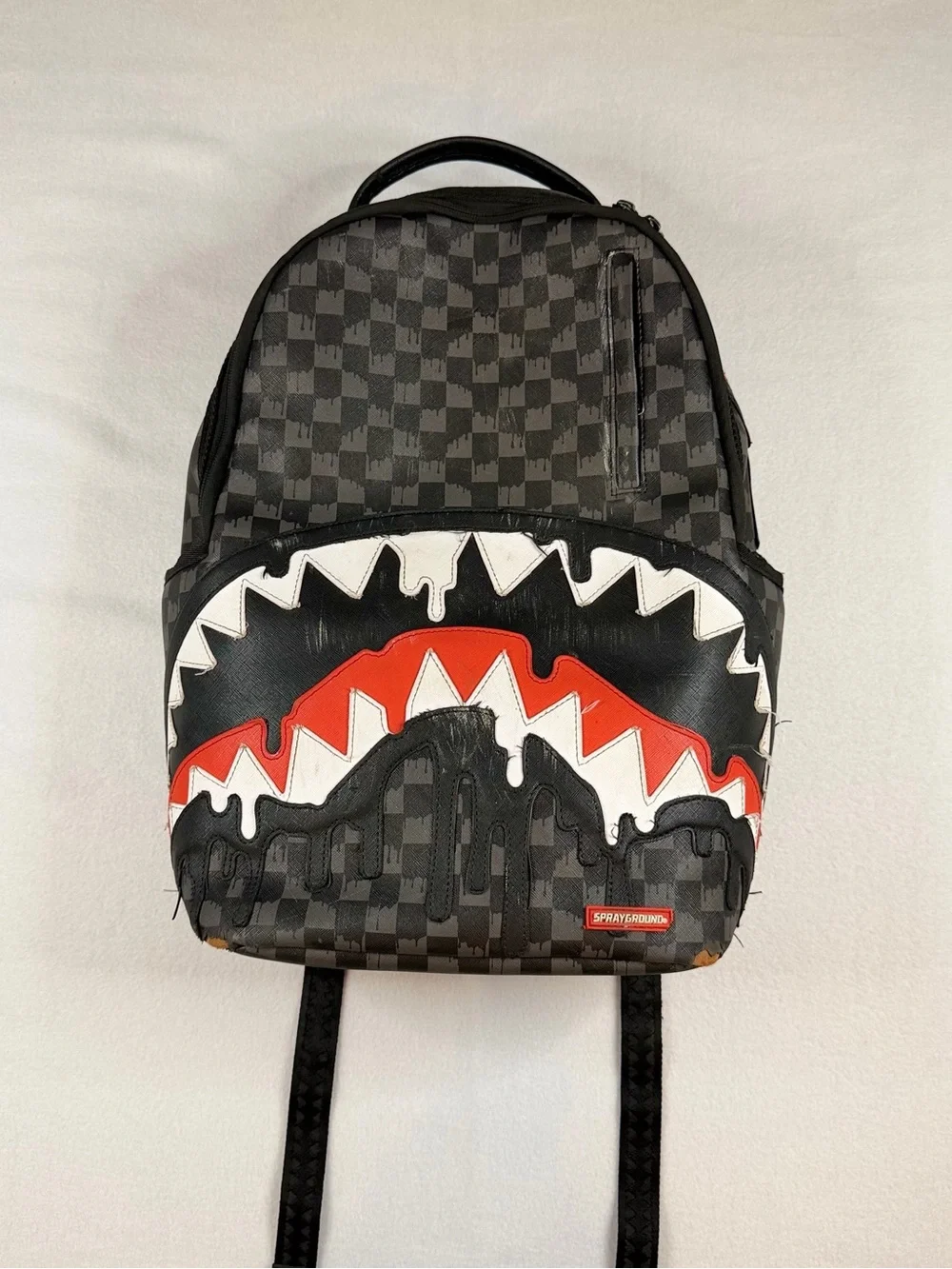 Sprayground Black Checkered Backpack with White and Red Shark Graphic